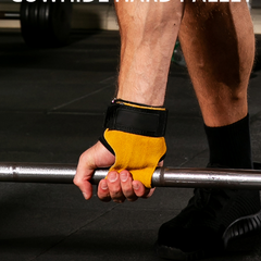 Person holding a barbell with yellow and black wrist support in a gym setting