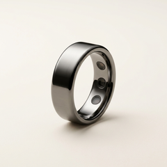 Titanium smart ring on a warm off-white background
