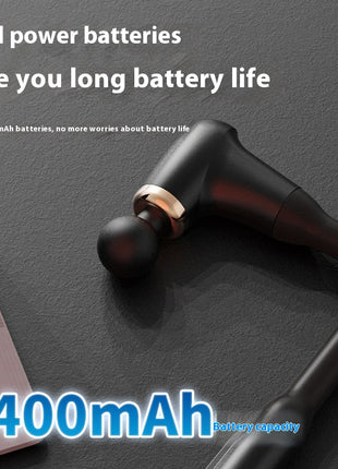 Black wireless earbuds with 2400mAh battery capacity on a dark surface next to a laptop.