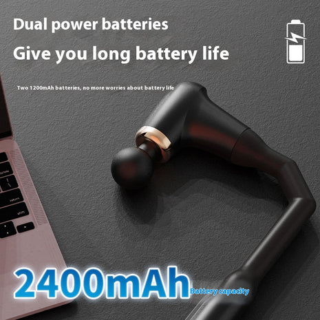 Black wireless earbuds with 2400mAh battery capacity on a dark surface next to a laptop.