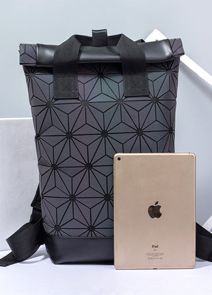 Black geometric-patterned backpack with a gold iPad on a light gray background