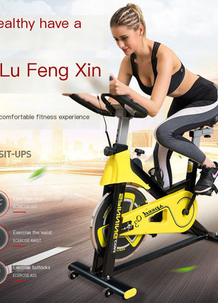 Woman using a yellow exercise bike with promotional text and branding.