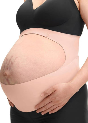 Pregnant person wearing a beige maternity support belt on a white background