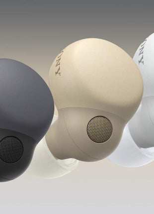 Three wireless earbuds in black, beige, and white on a gradient background