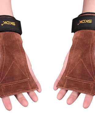 Brown leather weightlifting gloves with black wrist straps on a white background